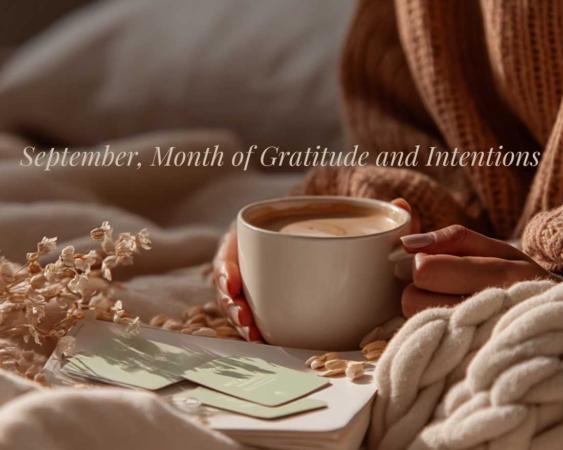 Flatlay of a cozy September scene with daily selfcare cards, warm cup of coffee, cozy blanket, and soft natural light — symbolizing mindfulness, gratitude practices, and setting new intentions for the month of September.